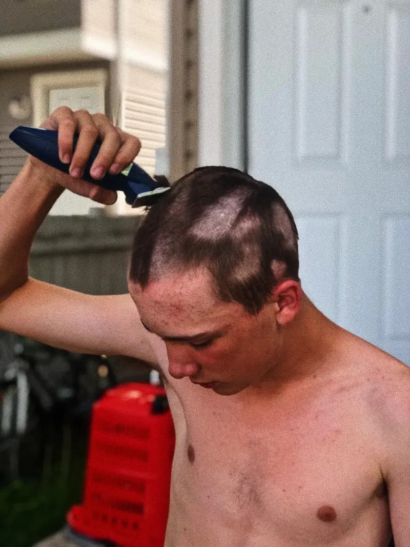 A boy shaving his head
